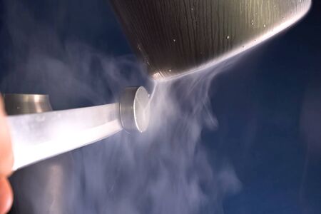 Liquid air, pouring liquefied air into a thermos.の写真素材