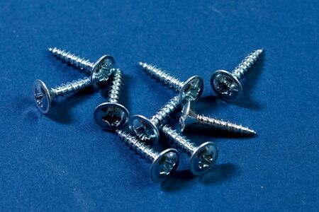 Galvanized screws on a blue background. Wood screws.の写真素材
