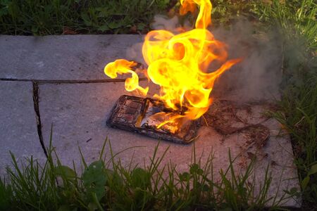 Burning smartphone, burning mobile phone. Flammable telephoneの写真素材
