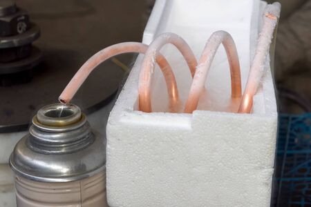 Liquid air, pouring liquefied air into a thermos.の写真素材
