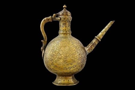 Copper kettle with patterns, kettle on a black background.の写真素材