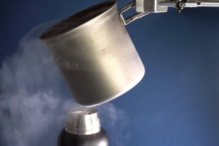 Liquid air, pouring liquefied air into a thermos.の写真素材