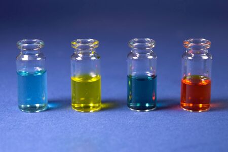 Multicolored liquids in glass vials of test tubes.の写真素材