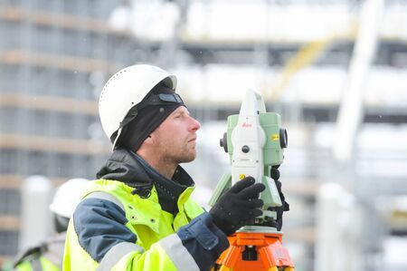 Tobolsk, Russia - June 14, 2018: Worker in a protective helmet and a suit on the zovoda. Worker protective clothing and a positive attitude to work.のeditorial素材