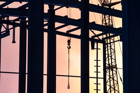 hoisting hooks hang on the pipes. The object of construction is industrial. Oil refinery. Construction of an oil industrial facilityの写真素材