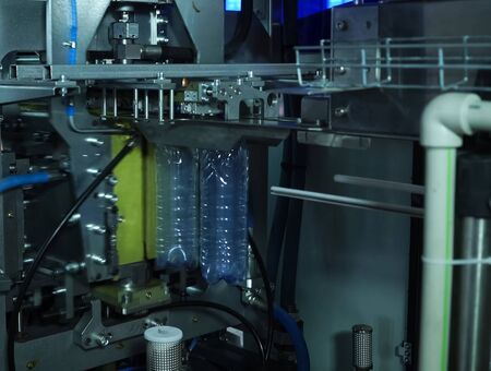 Filling line of sparkling water in a pet bottle. Mini factory for bottling water.の写真素材
