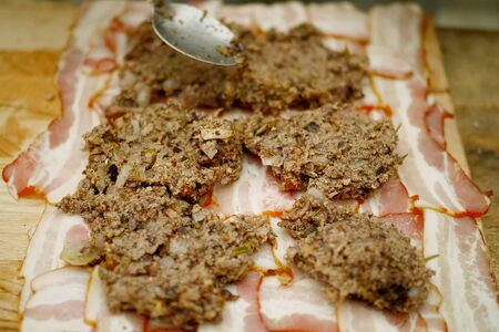 cooking meatloaf, minced meat with spices put in a roll.の写真素材