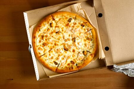 Delivered pizza in a box, delicious pizza.の写真素材