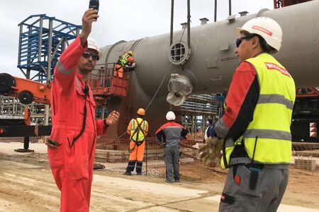Moscow, Russia - May 20, 2018: Installation of a distillation column at an oil refinery.のeditorial素材
