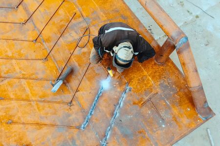 Welder at his work. A welder is cooking metal.の写真素材