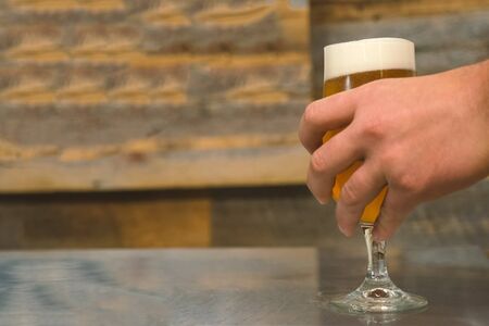 A glass of beer on the table, a glass of beer at the bar.の写真素材