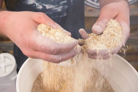 Ground barley in a container, grinding barley.