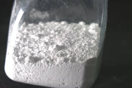 White powder in a transparent jar. white powder on the table.の写真素材