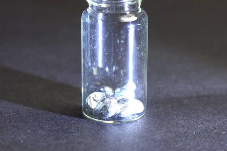 Pieces of solder are stored in a test tube. Pieces of metal.の写真素材