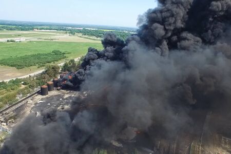 Oil storage fire. The tank farm is burning, black smoke is the combustion of hydrocarbons.の写真素材