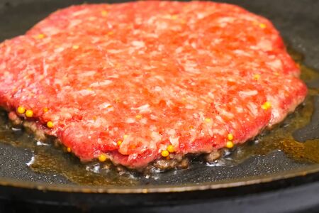 Raw cutlet is fried in a pan. Sandwich cutlet.の写真素材
