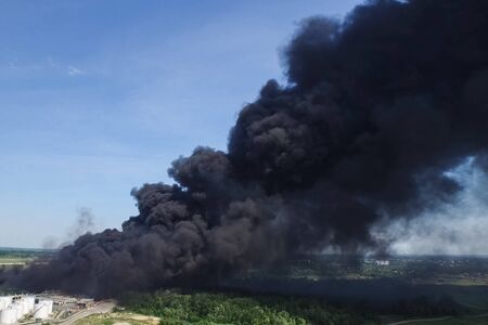 Oil storage fire. The tank farm is burning, black smoke is the combustion of hydrocarbons.の写真素材