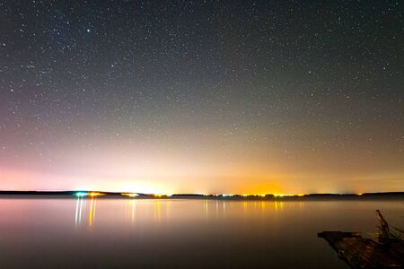 Starry sky background picture of stars in the night sky and the Milky Way. Starry sky over the lake.の写真素材
