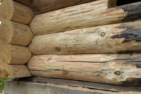Blackened from time to time a wooden log house, preparation for wood cleaning and grinding.の写真素材