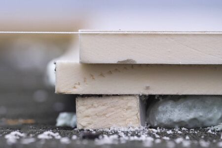 Roofing insulation, installation of insulation sheets on foam. Foam and insulation.の写真素材