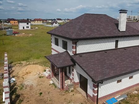 House with a roof from a bituminous tile. Bituminous tile for a roof. a roof from a bituminous tile.の写真素材