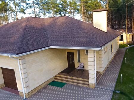 House with a roof from a bituminous tile. Bituminous tile for a roof. a roof from a bituminous tile.の写真素材