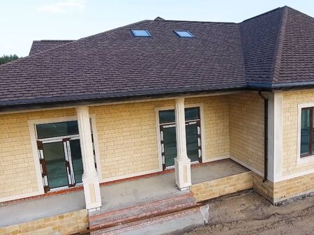 House with a roof from a bituminous tile. Bituminous tile for a roof. a roof from a bituminous tile.の写真素材