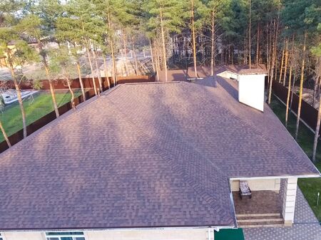 House with a roof from a bituminous tile. Bituminous tile for a roof. a roof from a bituminous tile.の写真素材