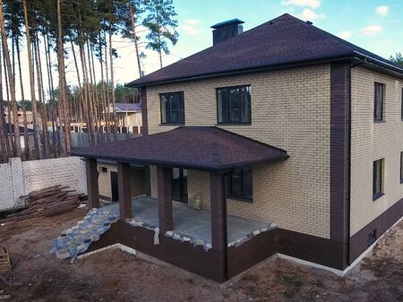 House with a roof from a bituminous tile. Bituminous tile for a roof. a roof from a bituminous tile.の写真素材