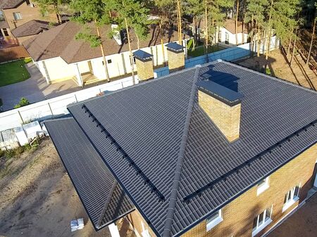 House with a ceramic tile roof. cement-sand roof tiles.の写真素材