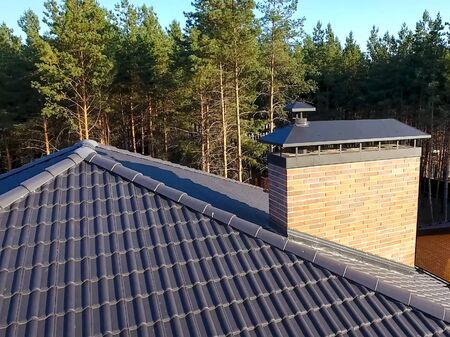 House with a ceramic tile roof. cement-sand roof tiles.の写真素材