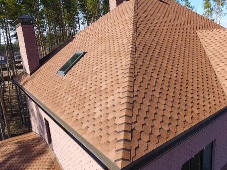 House with a roof from a bituminous tile. Bituminous tile for a roof. a roof from a bituminous tile.の写真素材