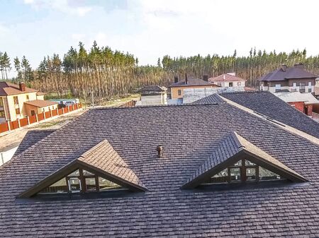 House with a roof from a bituminous tile. Bituminous tile for a roof. a roof from a bituminous tile.の写真素材
