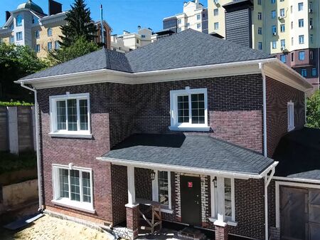House with a roof from a bituminous tile. Bituminous tile for a roof. a roof from a bituminous tile.の写真素材
