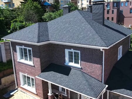 House with a roof from a bituminous tile. Bituminous tile for a roof. a roof from a bituminous tile.の写真素材