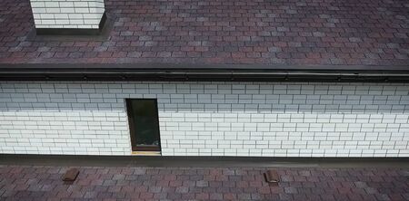 House with a roof from a bituminous tile. Bituminous tile for a roof. a roof from a bituminous tile.の写真素材