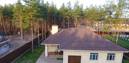 House with a roof from a bituminous tile. Bituminous tile for a roof. a roof from a bituminous tile.の写真素材