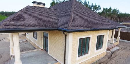 House with a roof from a bituminous tile. Bituminous tile for a roof. a roof from a bituminous tile.の写真素材