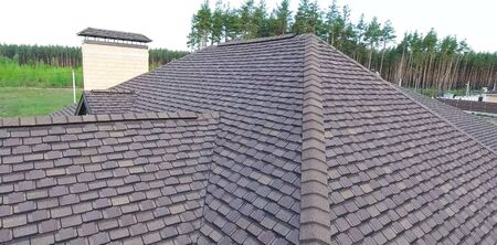 House with a roof from a bituminous tile. Bituminous tile for a roof. a roof from a bituminous tile.の写真素材