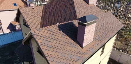 House with a roof from a bituminous tile. Bituminous tile for a roof. a roof from a bituminous tile.の写真素材
