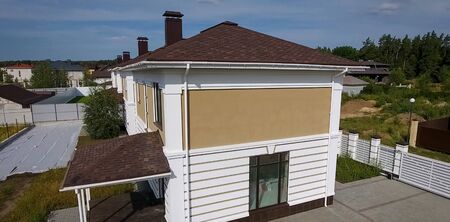 House with a roof from a bituminous tile. Bituminous tile for a roof. a roof from a bituminous tile.の写真素材