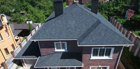 House with a roof from a bituminous tile. Bituminous tile for a roof. a roof from a bituminous tile.の写真素材