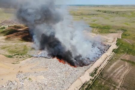 Burning trash. fire at the landfill. Burning garbage. Garbage dump, top view of the trash. Landfill.の写真素材