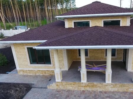 House with a roof from a bituminous tile. Bituminous tile for a roof. a roof from a bituminous tile.の写真素材