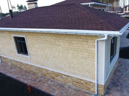 House with a roof from a bituminous tile. Bituminous tile for a roof. a roof from a bituminous tile.の写真素材