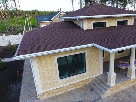 House with a roof from a bituminous tile. Bituminous tile for a roof. a roof from a bituminous tile.の写真素材