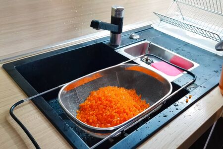 Red caviar in a sieve for washing. Flushing red caviar.の写真素材