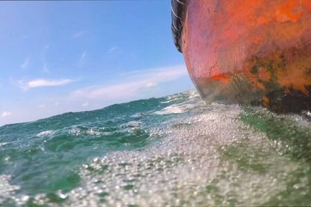 The edge of a boat sailing in the sea. Boat in the water.の写真素材