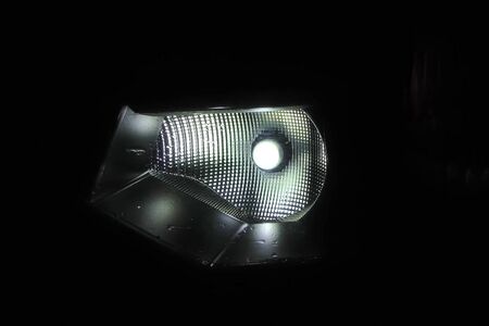 The xenon lamp in the car's headlight glows.の写真素材