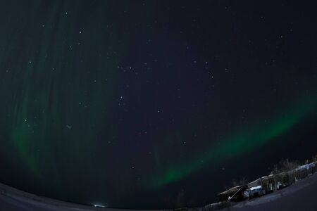 Aurora borealis in the night northern sky. Ionization of air particles in the upper atmosphere.の写真素材